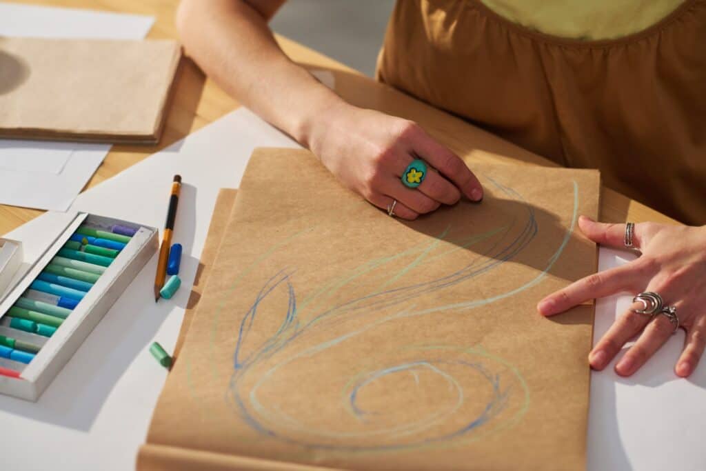 Woman using art therapy materials during a therapy session for emotional overwhelm, anxiety, and self-expression