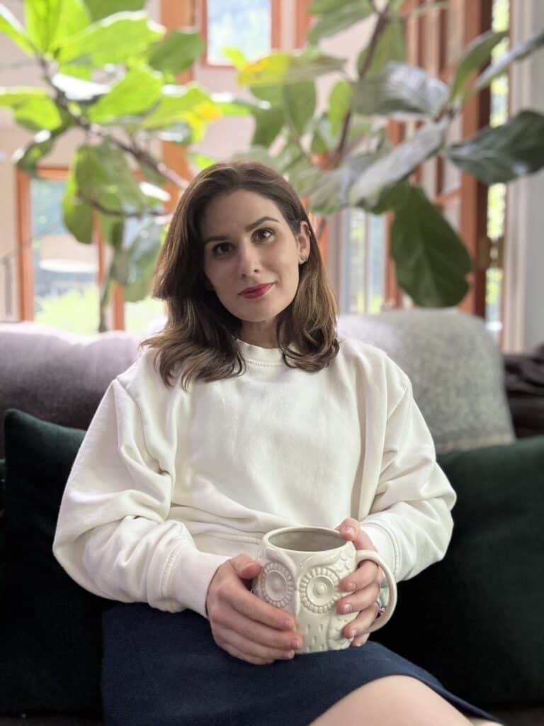 Aubrey Bodt, therapist for women and mothers in Maryland, sitting in a calm, natural light setting holding a mug